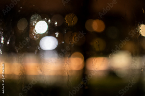 raindrops on the window against the background of the night city © Александр Клюйко