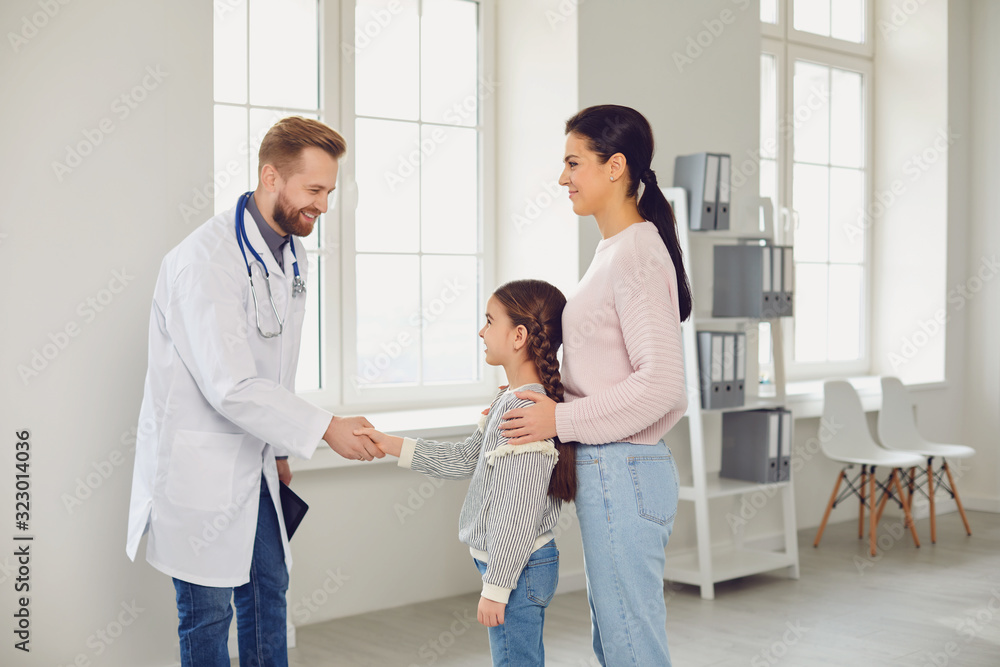 Happy family on a visit to the doctor in the office of a doctor. Happy family on a visit to the doctor in the office of a doctor.