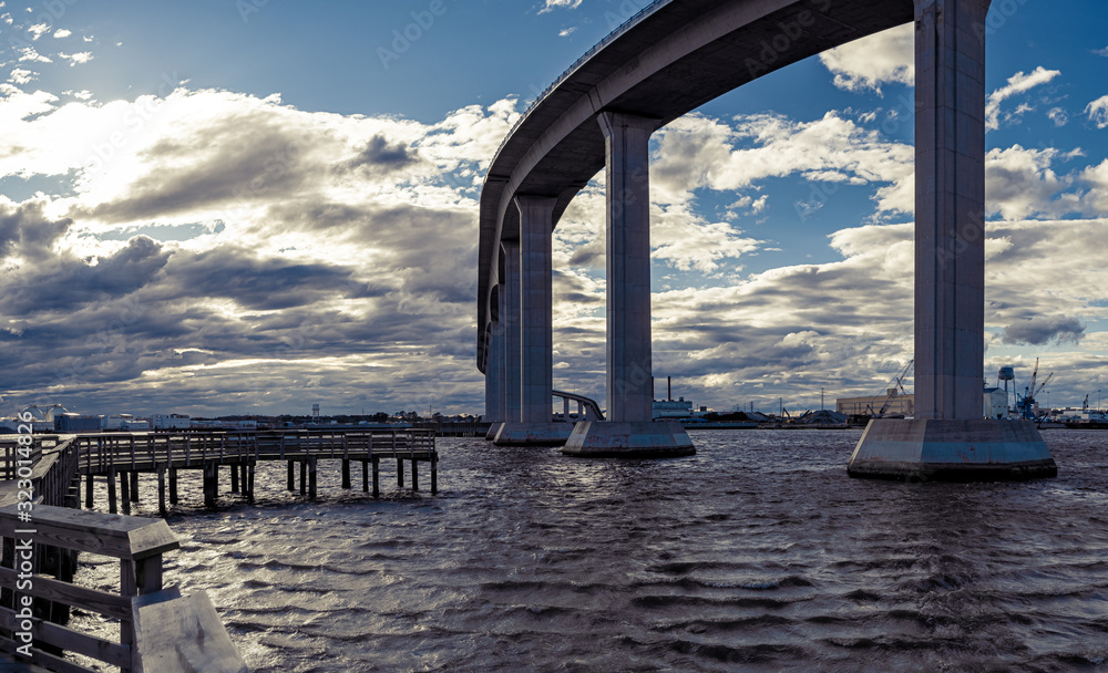 Dock and a large bridge on the Elizabeth River with storm clouds rolling in from the distance