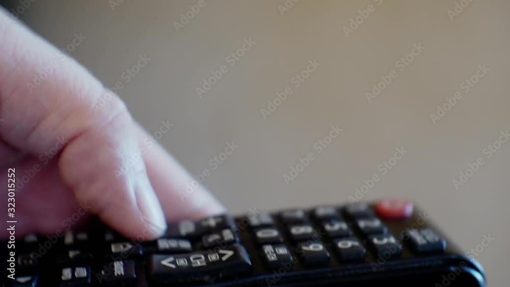 modern technologies.male hand holds a TV remote control.close-up.shallow depth of field modern technologies.male hand holds a TV remote control.close-up.shallow depth of field
