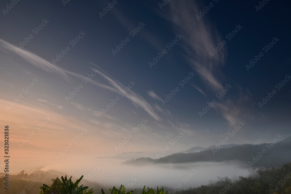 Twilight blue sky over a foggy valley in a morning