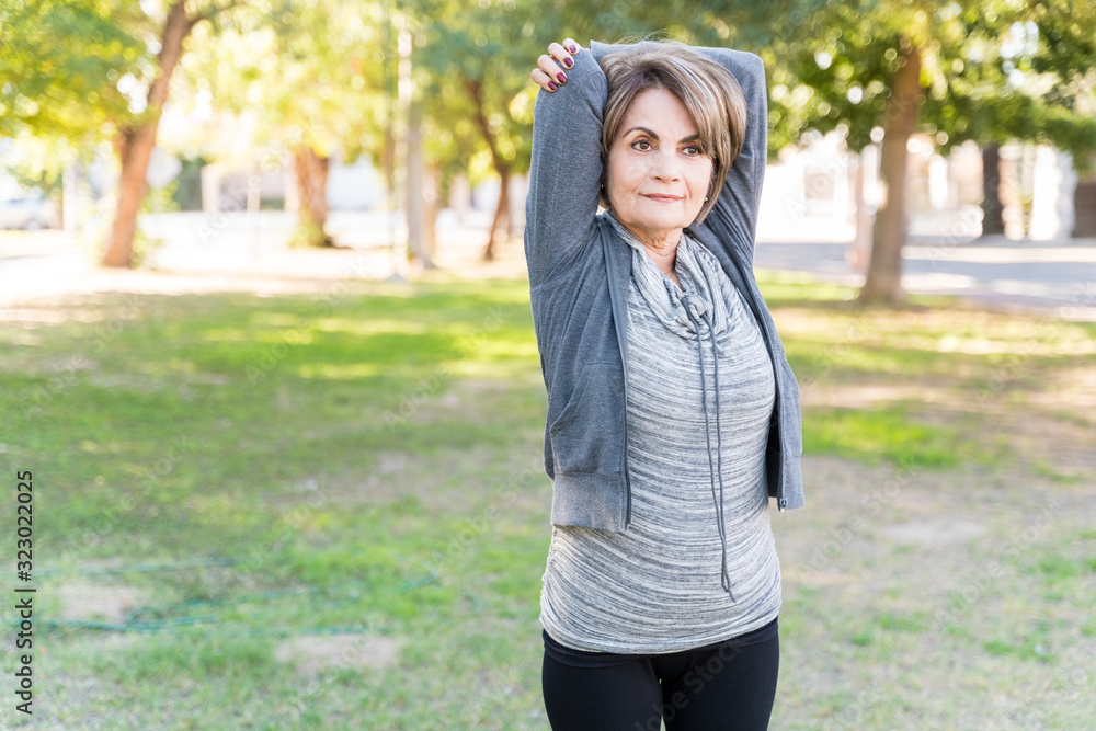 Active Senior Woman Exercising With Arms Raised Active Senior Woman Exercising With Arms Raised