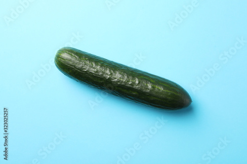 Fresh cucumber on blue background, space for text