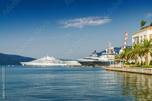 Beautiful embankment on the background of luxury yachts at the port of Tivat, Montenegro.