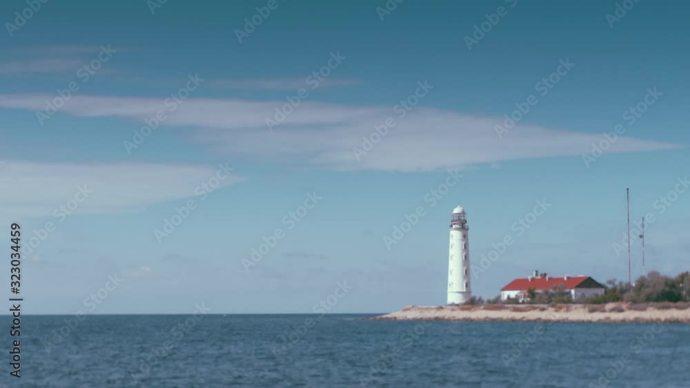beautiful old white Lighthouse seascape where clouds are animated like a time lapse, but the ocean, waves and shoreline are motionless. Can be used in a loop for endless playing Cinemagraphs. beautiful old white Lighthouse seascape where clouds are animated like a time lapse, but the ocean, waves and shoreline are motionless. Can be used in a loop for endless playing Cinemagraphs.