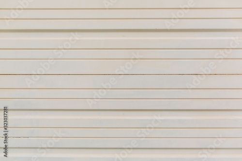 white cream metal siding outdoor exterior wall similar to a garage or metal shed building