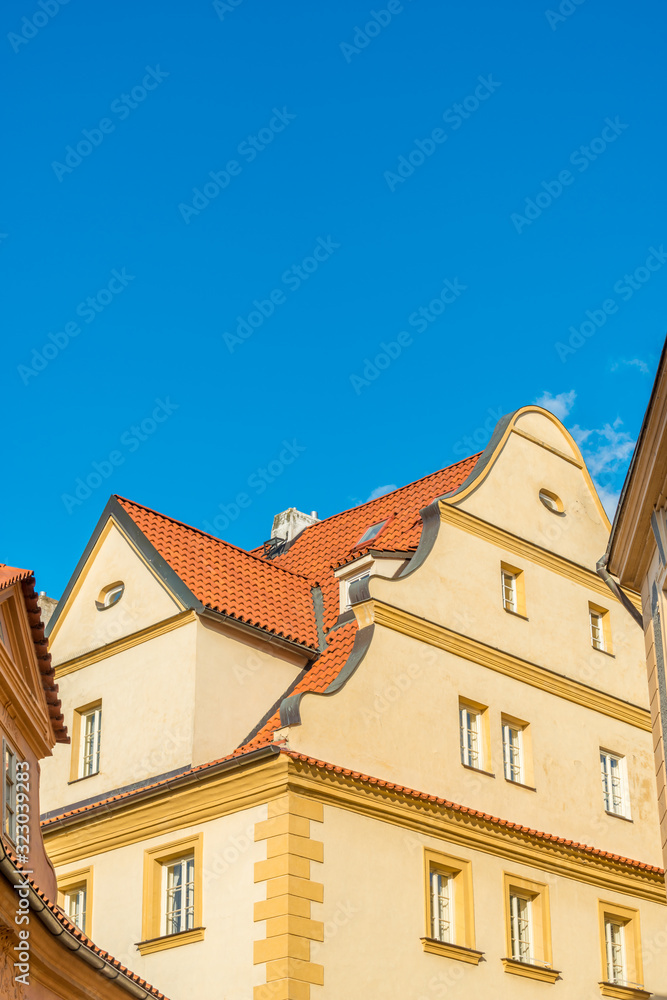 View of the top of old buildings with red roof and blue sky at Prague city Czech republic.