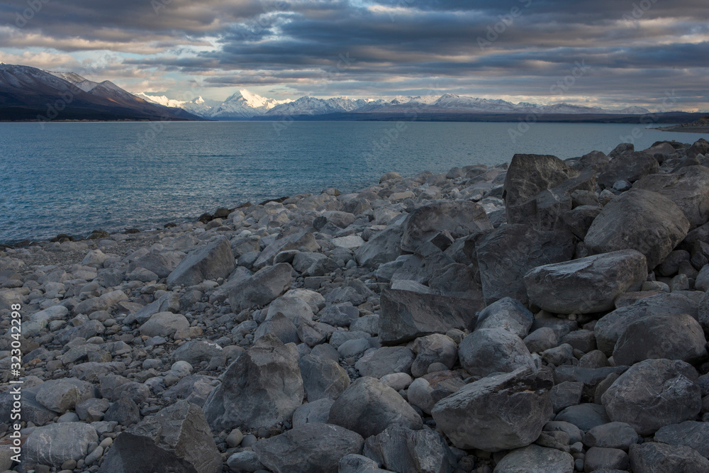 Rocky beach at Lake Pukaki Mount Cook New Zealand Clouds Evening light