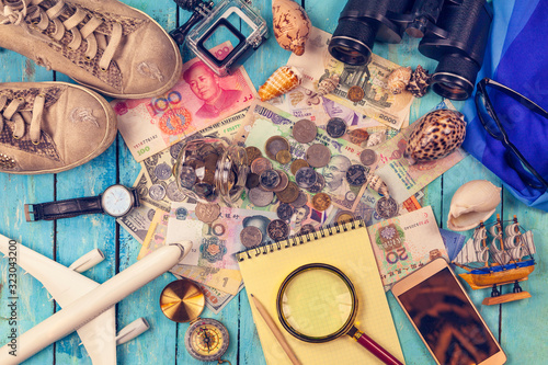 Travel concept background. Overhead view of Traveler's accessories, Essential vacation items, Essential vacation items: sneakers, binoculars, notepad, watch, phone, glasses, hat, passport, money;
