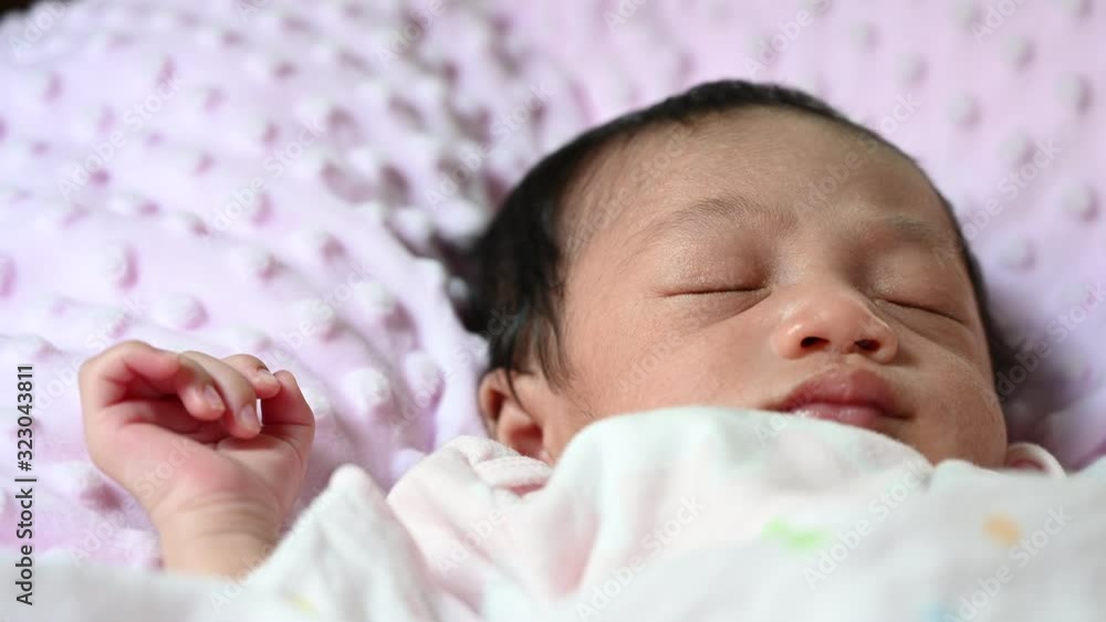 4K Close up new born asian baby sleep or nap on the pink blanket. Happy family and baby concept background. 4K Close up new born asian baby sleep or nap on the pink blanket. Happy family and baby concept background.