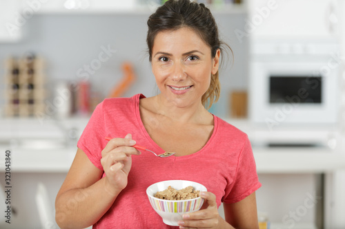 young woman eating oatmeal closeup