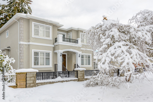 A typical american house in winter. Snow covered.