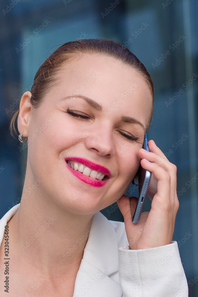 Vertical close up photo of happy cheerful relaxed businesswoman enjoy talking on cell phone. Female smiling with eyes closed, having good nice conversation, call on smartphone. Positive news, success Vertical close up photo of happy cheerful relaxed businesswoman enjoy talking on cell phone. Female smiling with eyes closed, having good nice conversation, call on smartphone. Positive news, success