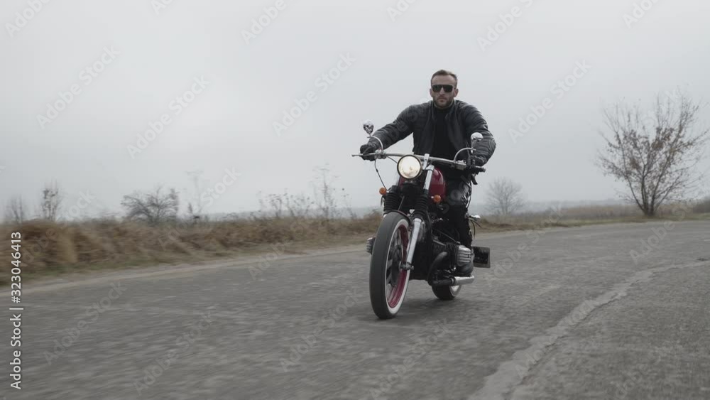 Motorbiker's adventure lifestyle with speed on road out of city Motorbiker's adventure lifestyle with speed on road out of city
