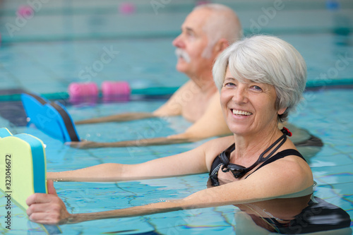 Valokuvatapetti happy senior couple taking swimming lessons
