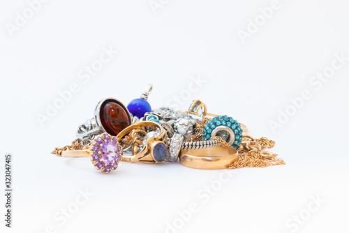 Collection of jewelry with beautiful golden ring with purple stone isolated on white background