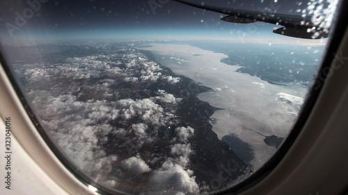 View of the frozen, winter Baikal from the airplane window.