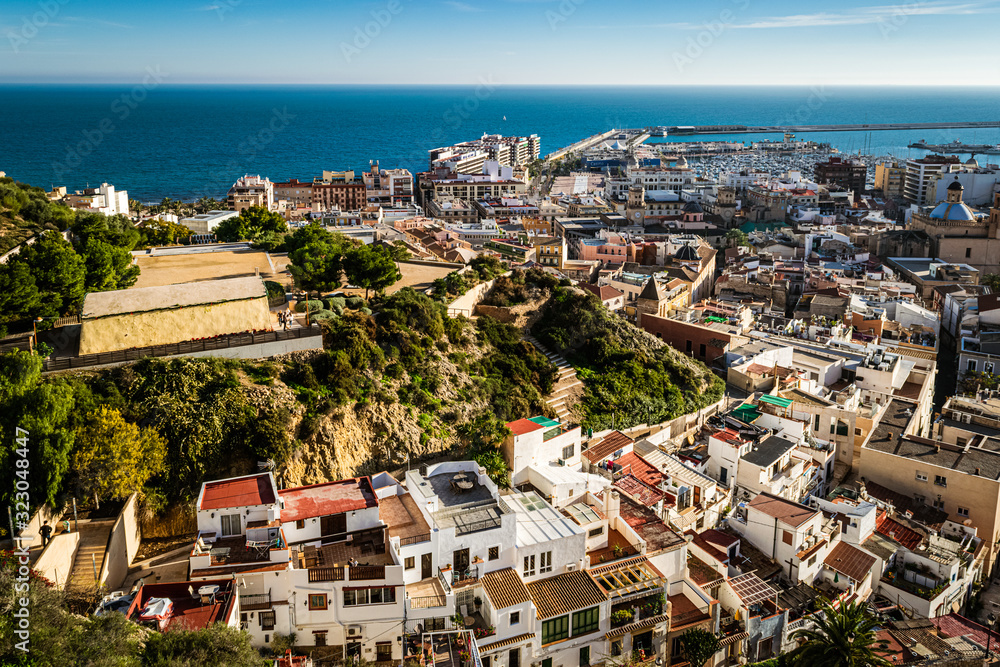 Cityscape of Alicante with old town and the port area on a sunny winter afternoon.