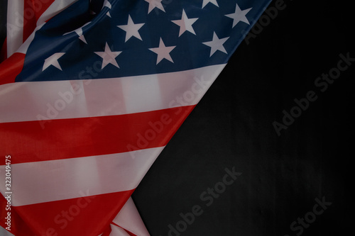 Close up of waving national usa american flag on black background with copy space.