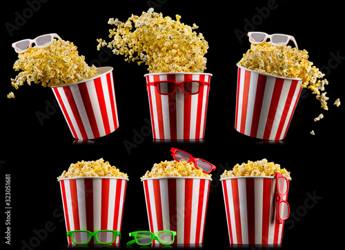 Set of buckets with popcorn and 3D glasses isolated on black background