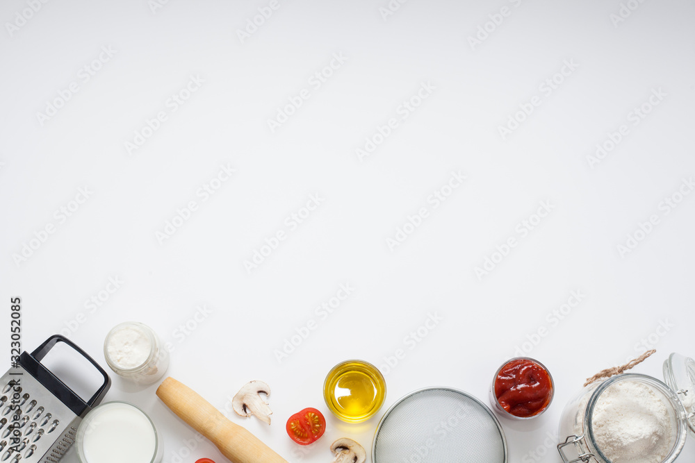 White background decorated with ingredients and appliances for cooking, baking. Concept of cooking or making food. White background decorated with ingredients and appliances for cooking, baking. Concept of cooking or making food.