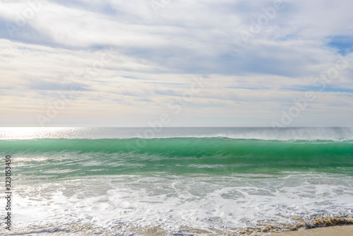 Set of pictures of a fantastic ocean wave in different stages. Cloudy sunrise sky. San Jose del Cabo. Mexico.