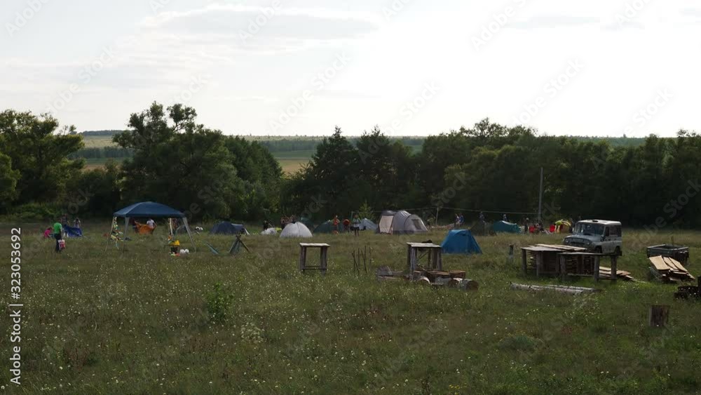 Russia, Saratov region - august, 2018 : Camping and tent in nature sunset. several families are vacationing and doing ecotourism. Russia, Saratov region - august, 2018 : Camping and tent in nature sunset. several families are vacationing and doing ecotourism.