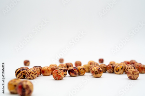 Scattered wooden decorated beads for craft. Macrame beads. Anima