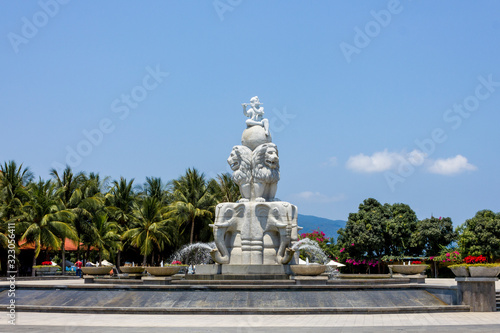 Sculpture in a fountain on a background of palm trees