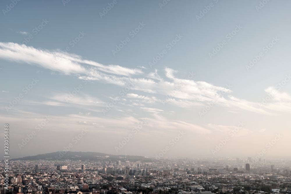 Panorama of city in sunny day with diagonal clouds