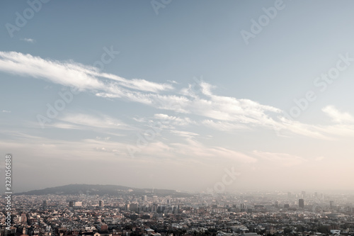 Panorama of city in sunny day with diagonal clouds