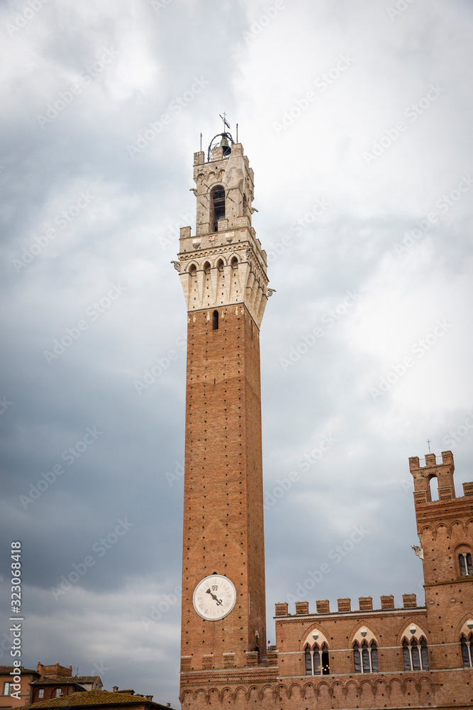 Torre del Mangia tower at Piazza del Campo square in Siena city, Tuscany, Italy
