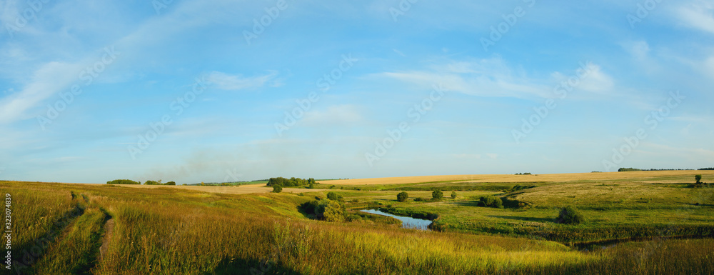 landscape with wheat fields and blue sky