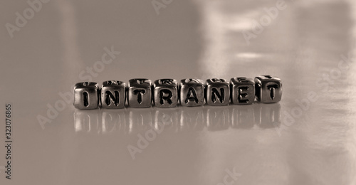 Intranet -  word from metal blocks - concept sepia tone photo on shine background photo