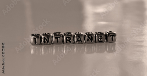 Intranet -  word from metal blocks - concept sepia tone photo on shine background