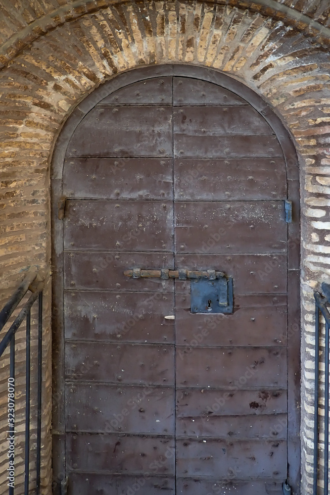 Rustic old wooden arched double doors