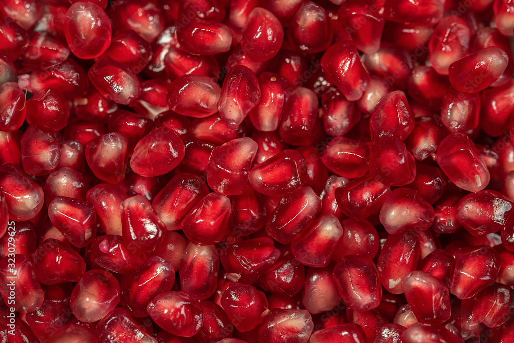 Close up of fresh organic pomegranate seeds. food background. Ripe red berries. Close up of fresh organic pomegranate seeds. food background. Ripe red berries.