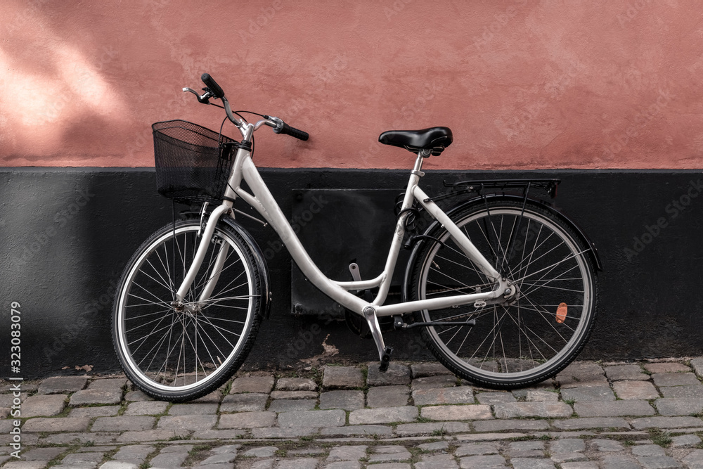 Bicycle near pink and black wall