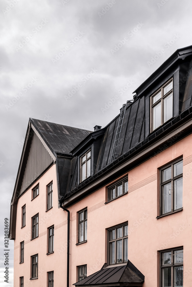 Pastel colored building with black roof