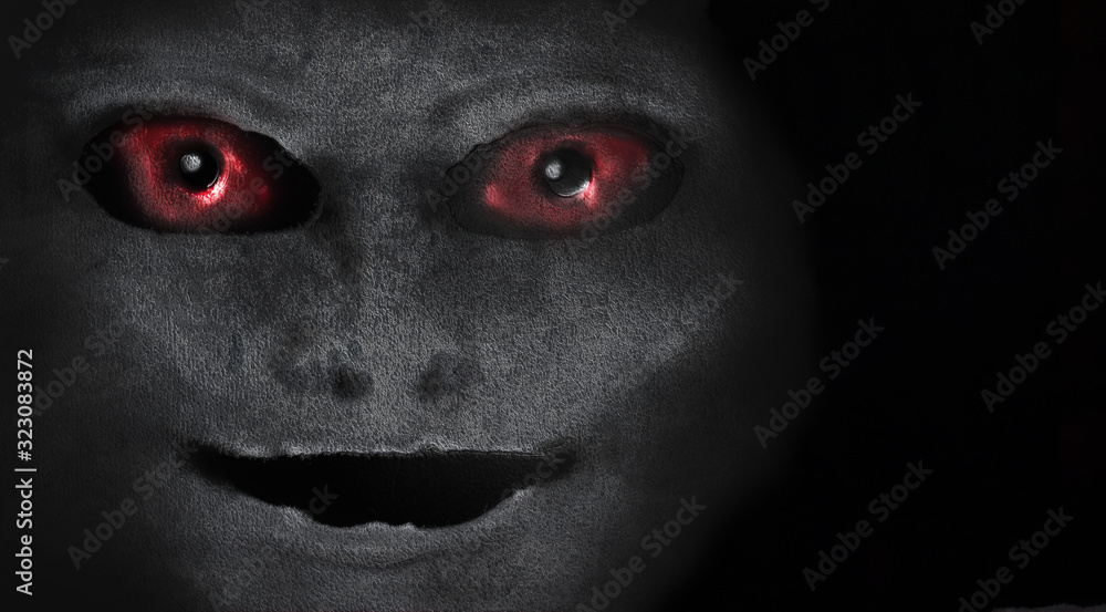 Scary creature with red eyes. Portrait of an alien or demon. A vision