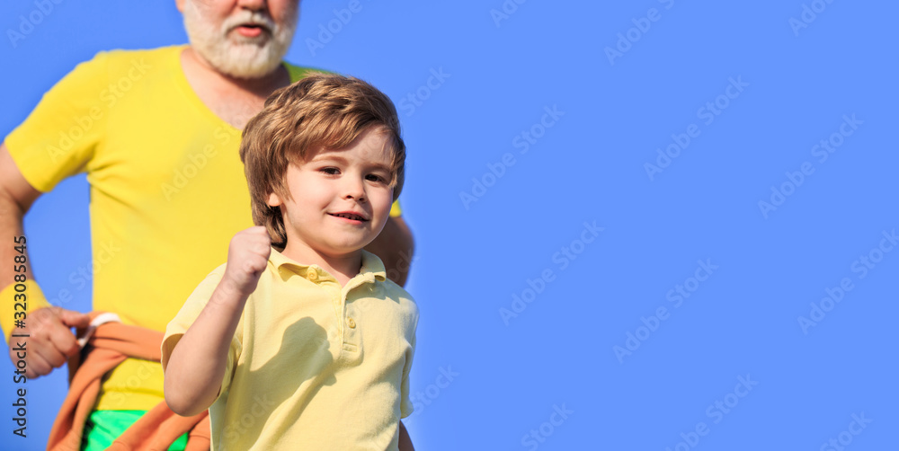 Sport for kids, active child running. Kid run on outdoor. Jogging for kid. Child running in stadium. Father and son play sports and run. Healthy sport activity for children. Copy space Sport for kids, active child running. Kid run on outdoor. Jogging for kid. Child running in stadium. Father and son play sports and run. Healthy sport activity for children. Copy space