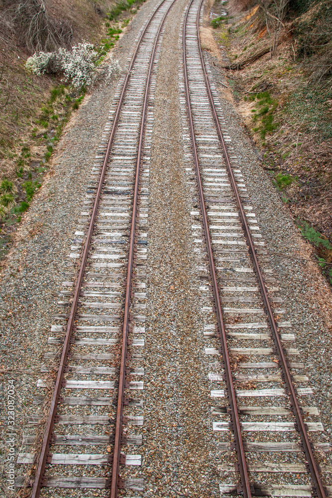 Steel train tracks heading toward town