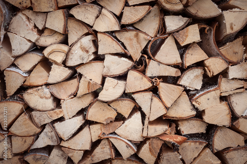 the woodpile of harvested stacked chopped firewood the woodpile of harvested stacked chopped firewood