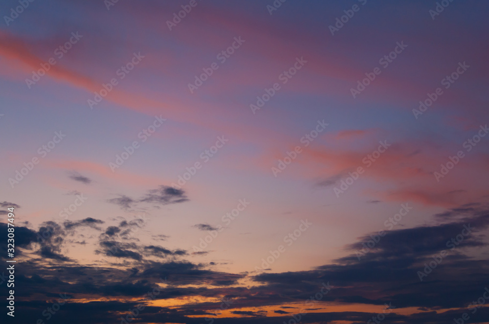 Fototapeta premium Colorful sunset sky over the horizon. Layered clouds.