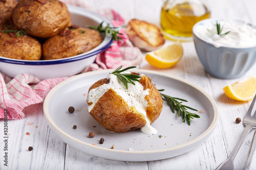 Whole potato roasted with rosemary and spices, served with sour cream sauce. Vegetarian dish. Whole potato roasted with rosemary and spices, served with sour cream sauce. Vegetarian dish.