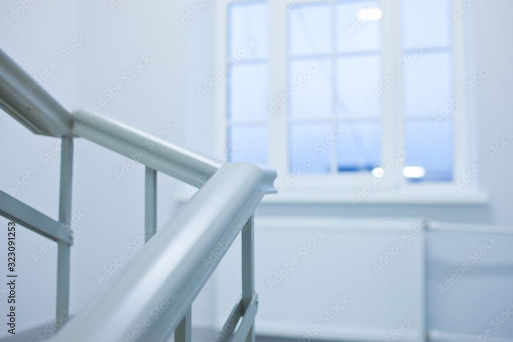 A white stairs up ladder in a new office building A white stairs up ladder in a new office building