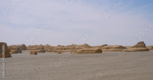 Nature landscape view of Yardang landform under sunny blue sky in Dunhuang UNESCO Global Geopark, Gansu China. photo