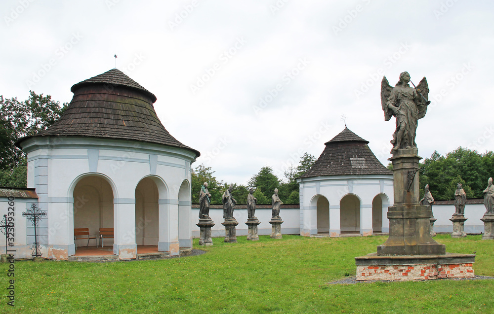 old building and statues of saints at former cemetery in Zdar nad Sazavou, Czech Republic
