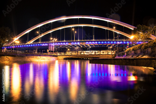 Overpass bridge reflected in the water at nigh © Chris M