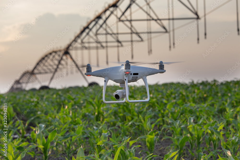 Drone in front of irrigation system in corn field Drone in front of irrigation system in corn field